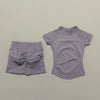 A light purple seamless yoga set for women featuring a short sleeve top and matching workout leggings.
