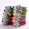 A stack of performance sports grip socks in various colors and patterns.