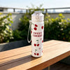 A white reusable water bottle with a silver cap and a design featuring red cherries and a heart.