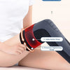 A close-up of a black compression band being applied to a person's knee, showing the adjustable strap and pressure tightening