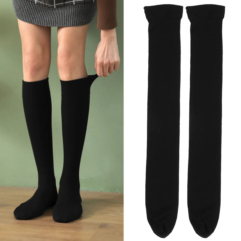 Black opaque thigh high elastic socks worn by a woman.
