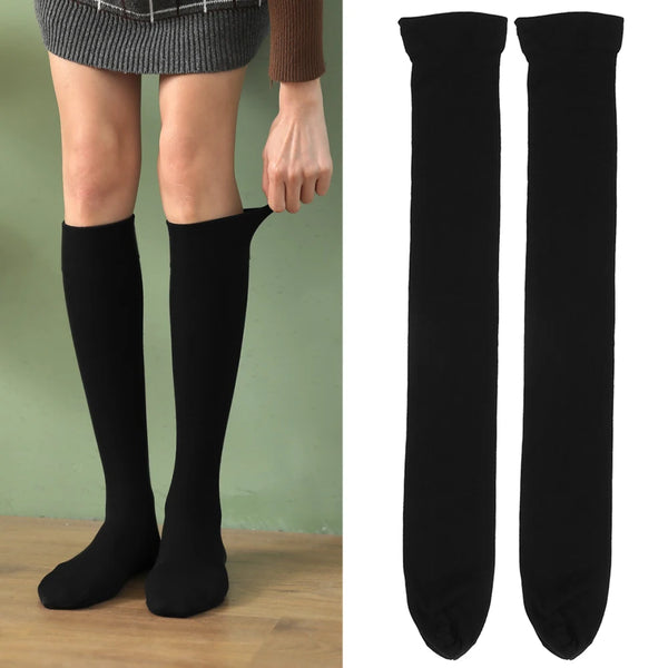 Black opaque thigh high elastic socks worn by a woman.