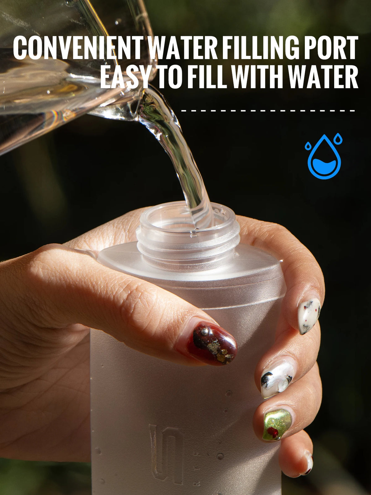 A hand pours water into a clear silicone hydration flask, demonstrating a convenient water filling port.