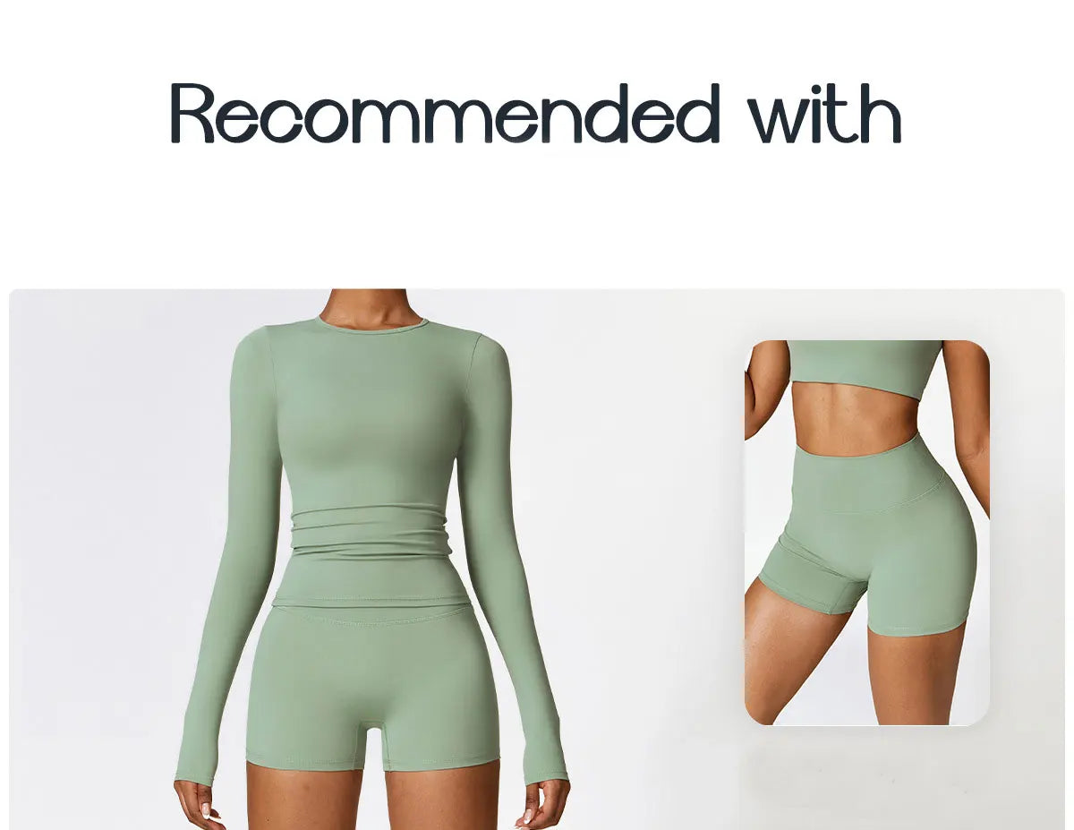 A model wearing a long sleeve, fitted, sage green yoga or fitness t-shirt.