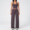 A woman wearing a dark purple women's premium fitness tracksuit top and matching pants.