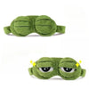 A green 3D sad frog sleep eye mask with large, expressive eyes.