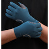 A close-up of a hand wearing dark teal cycling gloves with silicone palm pads against a black background.
