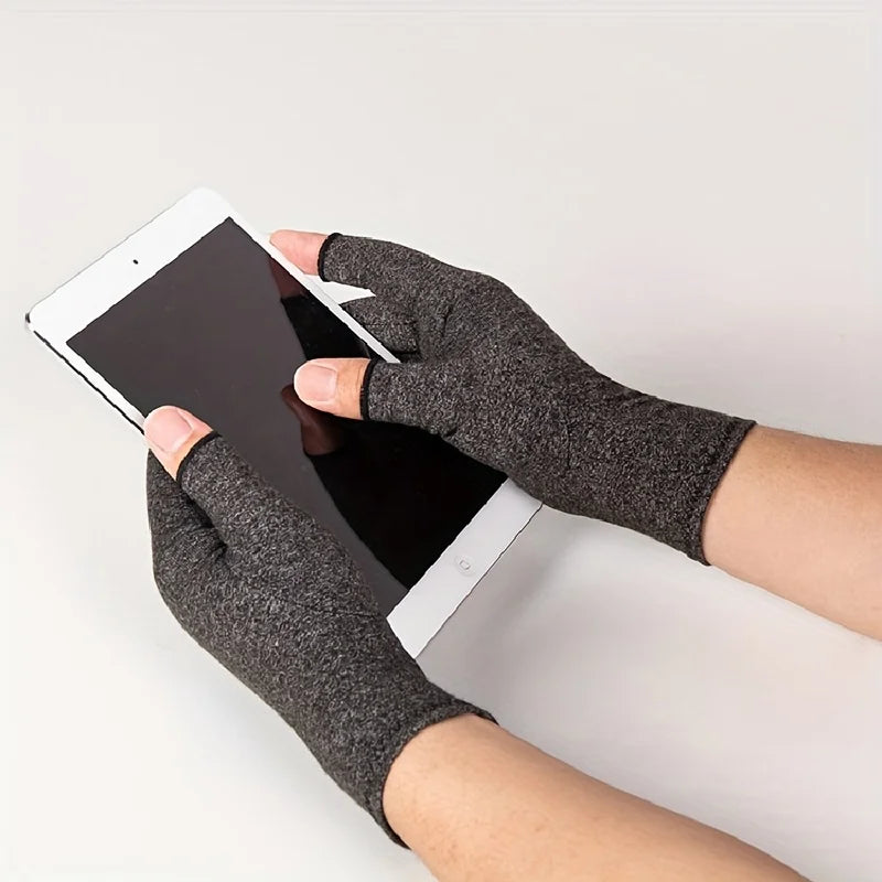 A hand wearing fingerless breathable gloves is holding a tablet device.