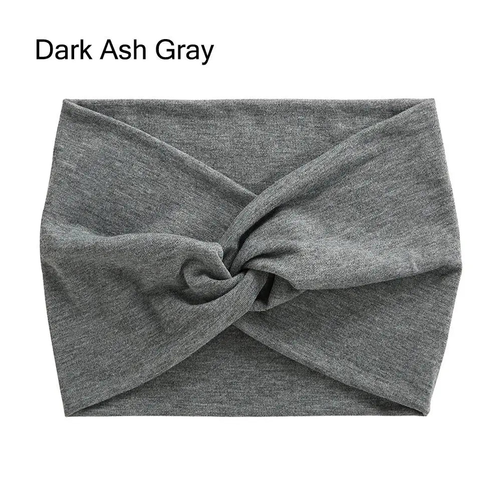A dark ash gray fabric headband is tightly cross-knotted and displayed flat.