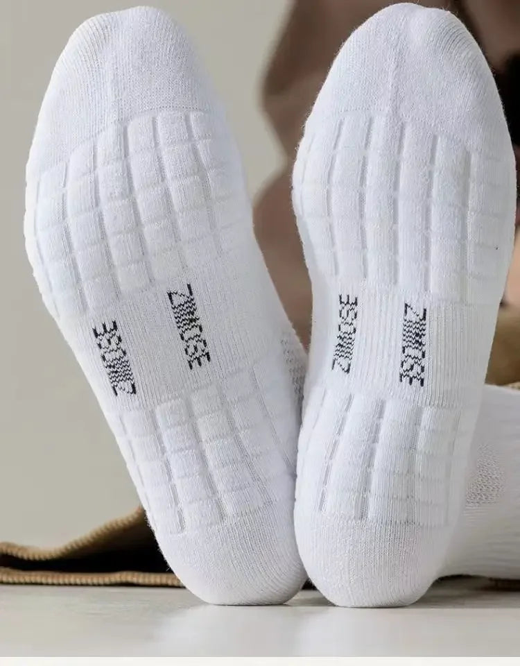 Pair of white breathable sports performance socks viewed from the bottom