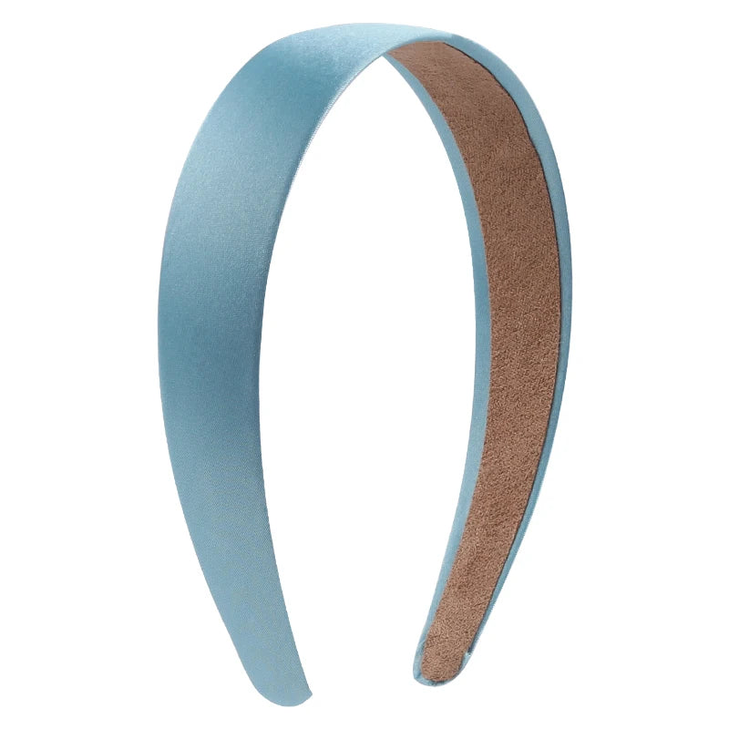 A curved satin hair band shown in light blue and brown colors.