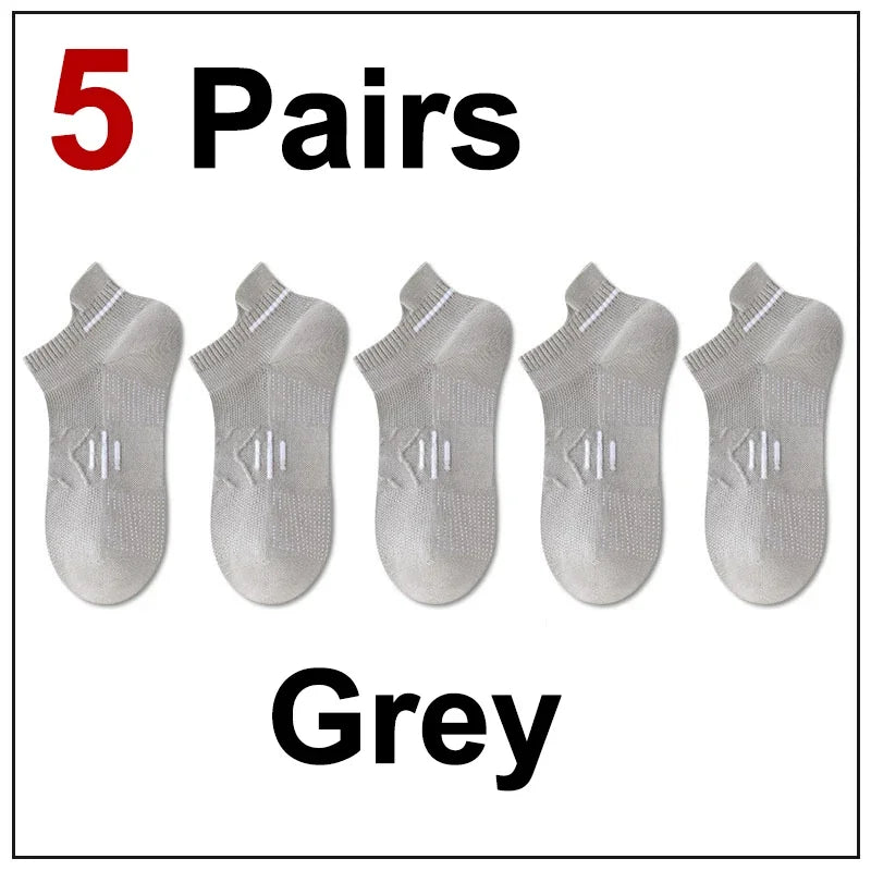 Five pairs of grey premium breathable men's running socks laid out for display.