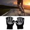 Black luminous skeleton hand gloves shown against a sunset background while cycling