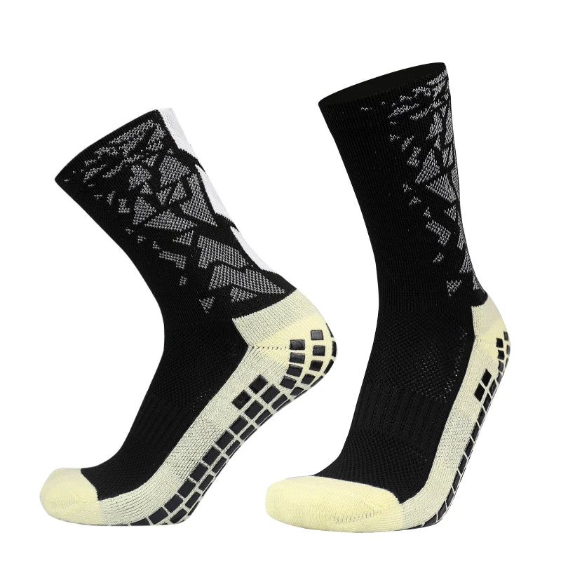 A pair of black and white anti-slip silicone football socks shown from the side.
