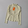 A light beige quick-dry yoga and fitness jacket shown flat lay.