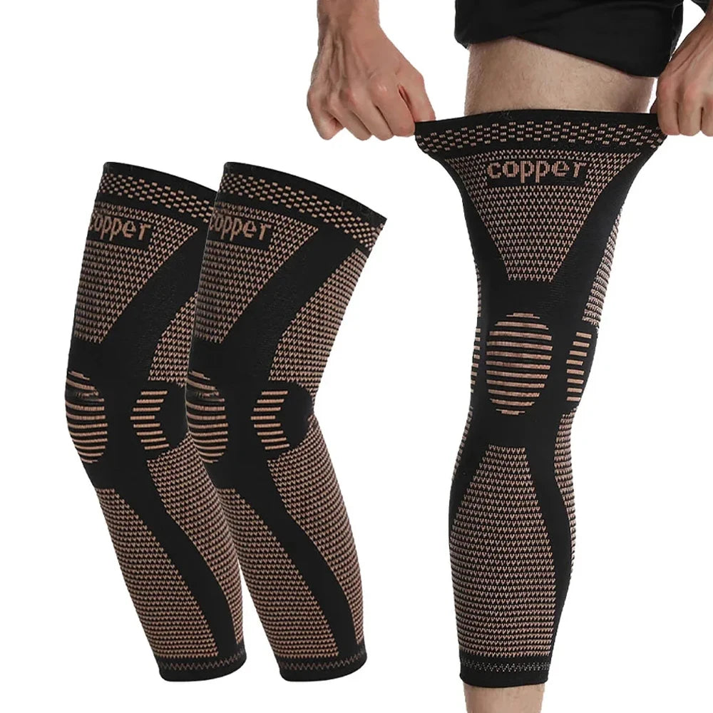 A person is wearing black copper ion infused knee compression sleeves on their legs.