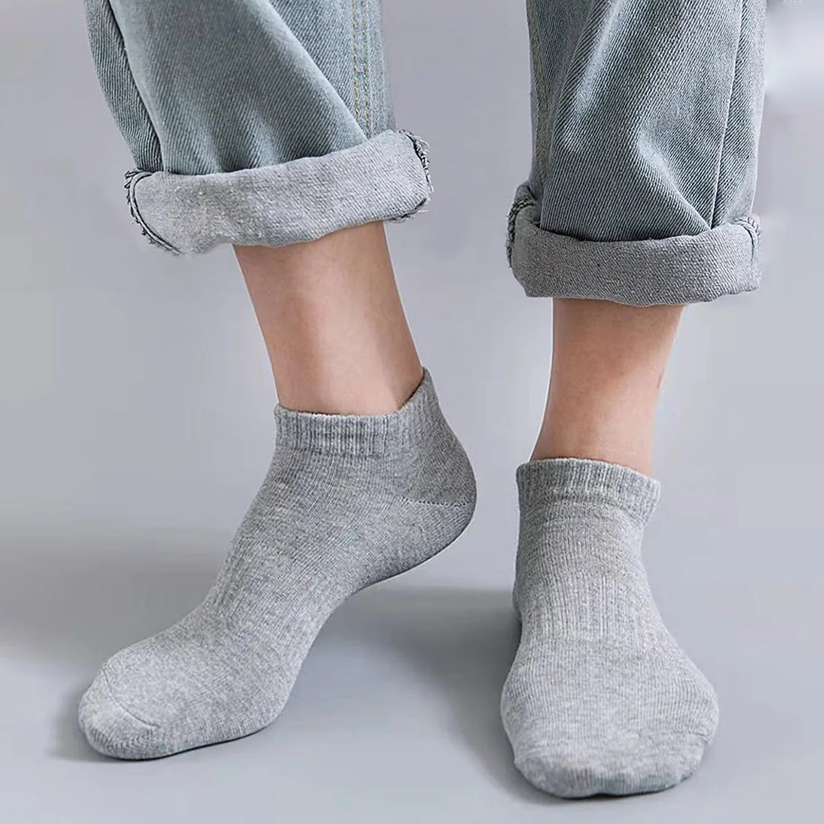 Gray unisex thin ankle socks folded and displayed on a light gray surface.