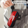 A red and black spider web shaped eyeglass pouch attached to a keychain, held by a person.