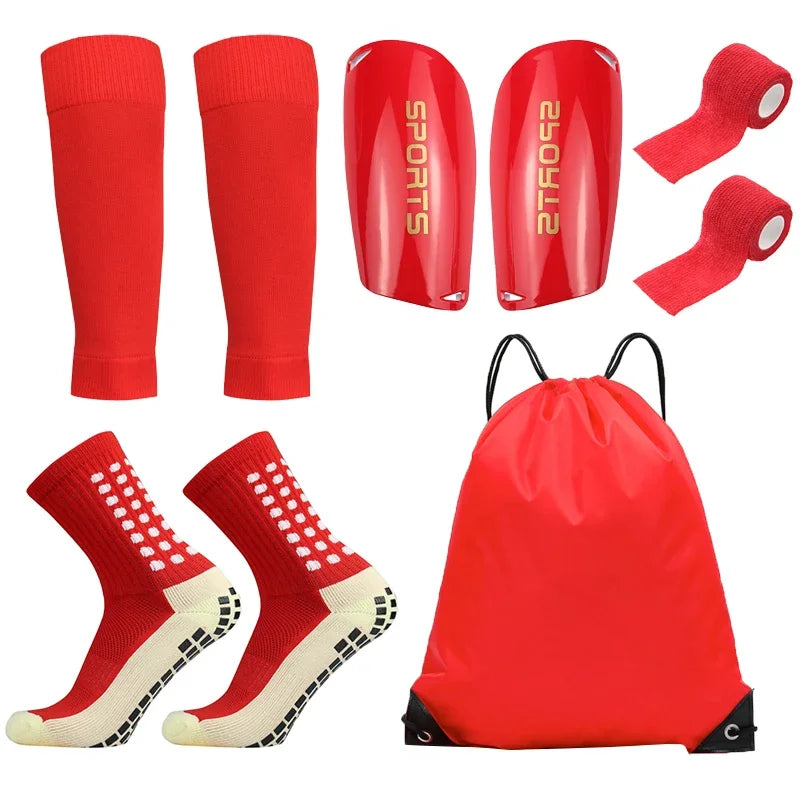 A set of red football training socks and shin guards, including individual pieces and a red storage bag.