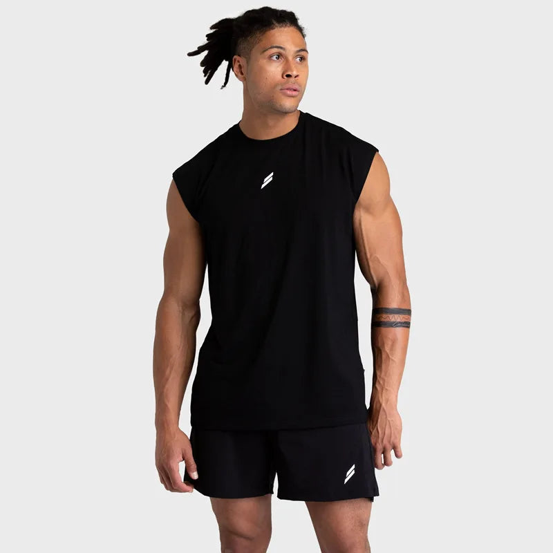 A muscular man wearing a black quick-drying sleeveless fitness tank top and black shorts.