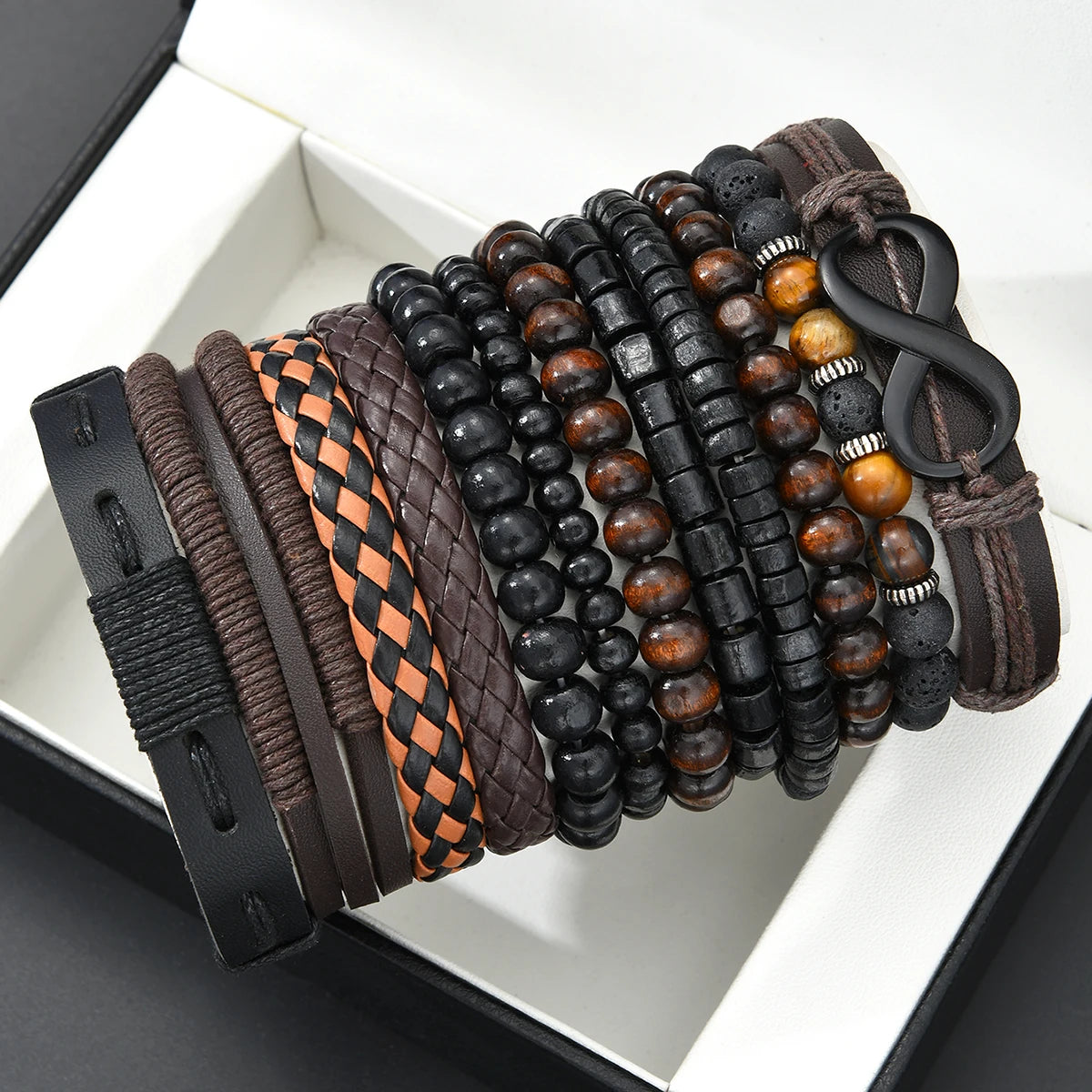 A collection of dark and light brown beaded leather bracelets arranged in a box.