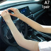 A pair of beige ice silk arm sleeves worn by a person driving a car.