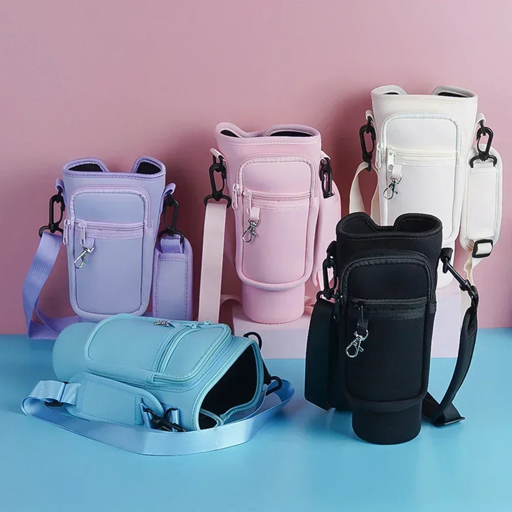 A collection of light colored neoprene water bottle carrier bags in various shades of purple, pink, and white displayed on a 