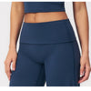 A model wearing dark blue flared high-waist yoga and fitness pants.
