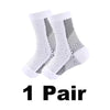 A pair of white compression ankle support braces with black mesh detailing.