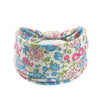 A pink and blue floral butterfly patterned fabric headband for fitness.