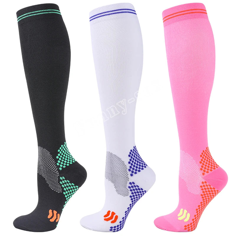 Three pairs of medical grade compression socks in black white and pink showing different patterns