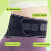A black adjustable lower back pain support belt shown on a person's torso, highlighting soft supports and cross tie straps.