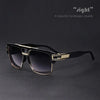 A pair of black sunglasses with gold accents resting on a dark surface.