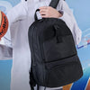A young man wearing a light gray jacket is holding a black multifunctional blue ball bag.