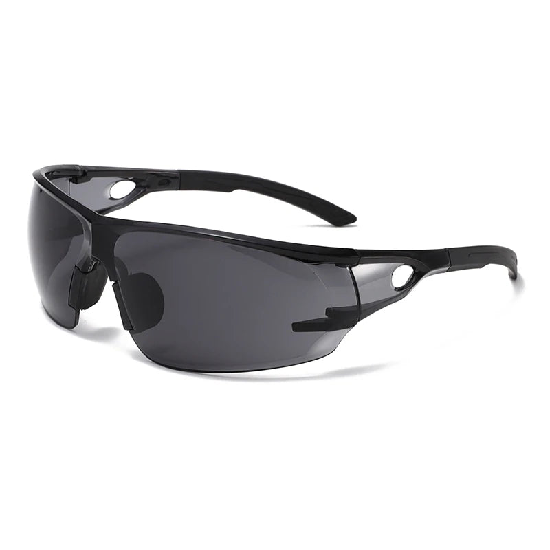 A pair of black safety goggles with a flexible strap and tinted lenses shown against a white background.