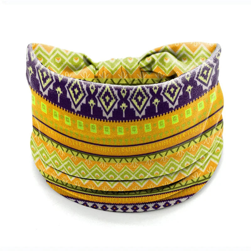 A colorful bohemian stretch cotton headband featuring geometric patterns in purple, yellow, and green.