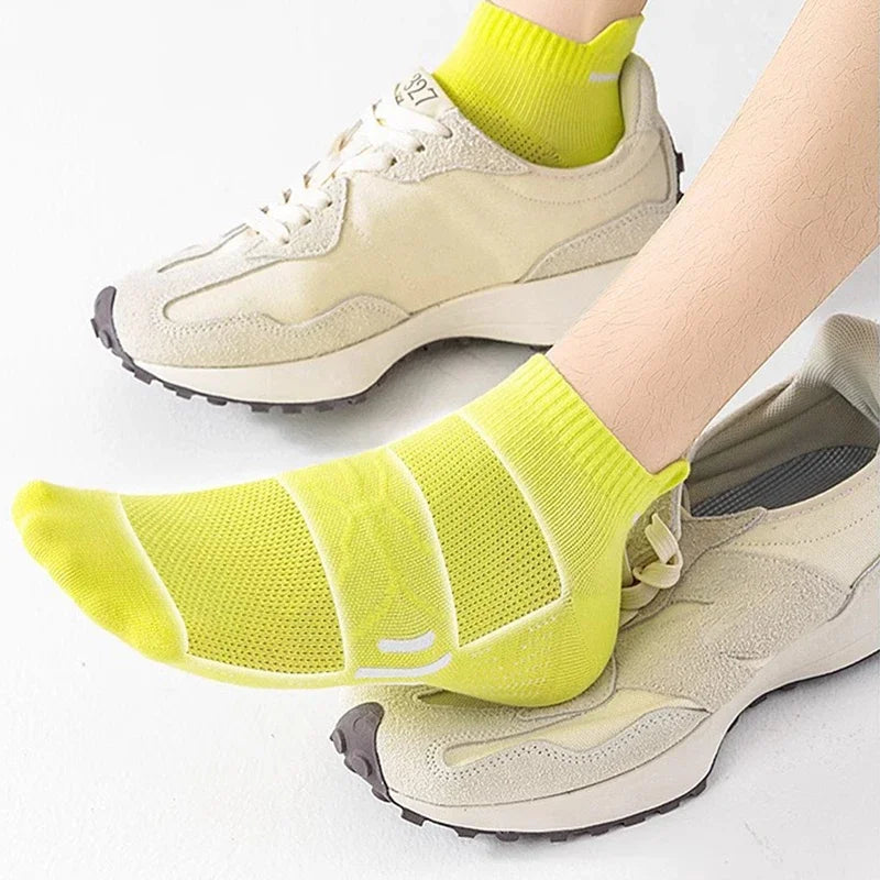 A pair of light beige running shoes paired with bright yellow breathable socks.