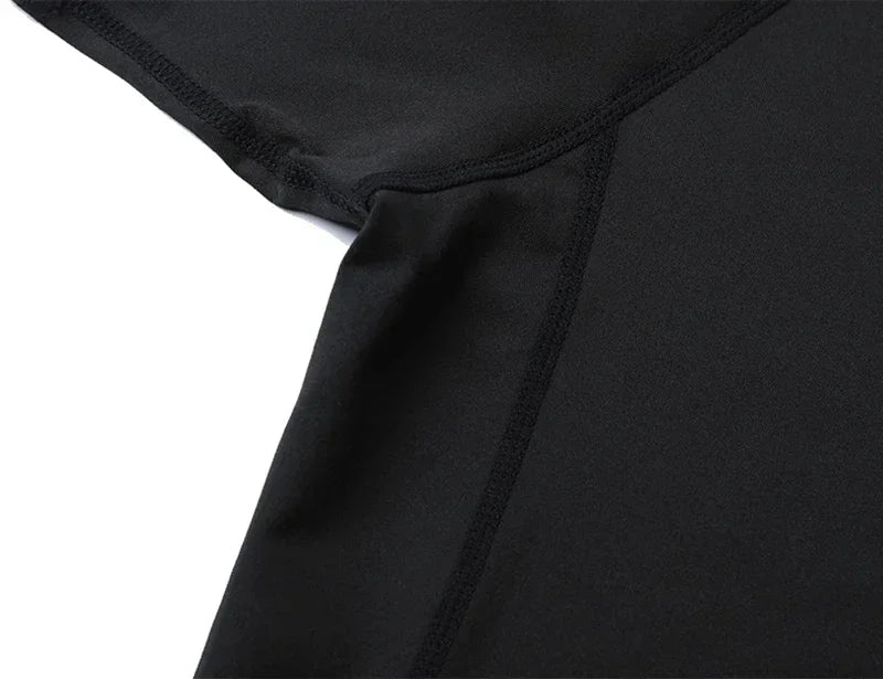 Black men's performance compression t-shirt sleeve and torso detail.