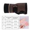 Black copper fiber wrist bracer with size chart showing measurements in inches and centimeters