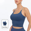 A model wearing a dark blue summer strappy yoga sports bra with built-in padding.