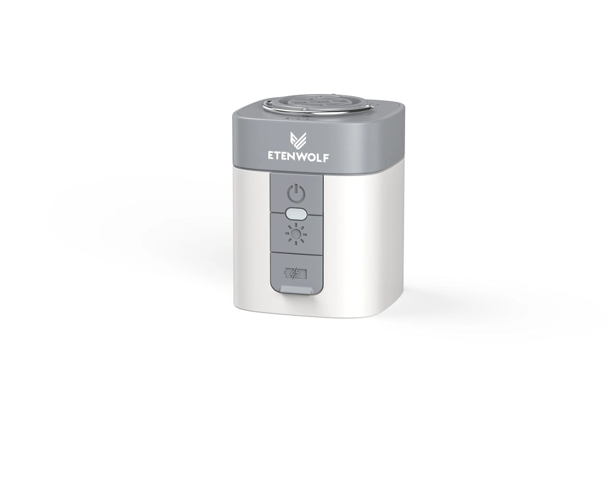 A silver portable electric air pump device with a round top and control buttons.