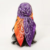 A purple and orange satin square scarf tied around dark hair