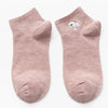 Pair of light pink cotton socks with a white embroidered bunny face
