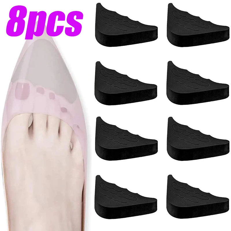Eight black adjustable EVA foot pads shown next to a foot for use in heels and shoes