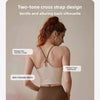 A woman wearing a two-tone cross strap sports bra with a gentle back silhouette and skin-friendly fabric.