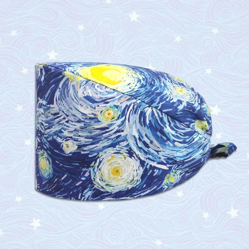 A navy blue printed cotton surgical cap featuring swirling white and yellow patterns.