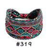 A patterned boho knotted cotton headband featuring geometric designs in black, pink, teal, and orange.
