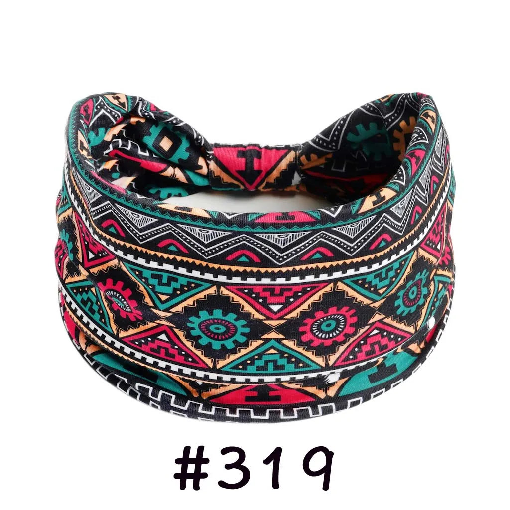 A patterned boho knotted cotton headband featuring geometric designs in black, pink, teal, and orange.