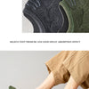 A close-up of olive green men's cotton crew socks being worn on a foot.