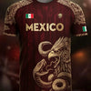 A dark red soccer jersey featuring an Aztec calendar style design and a large eagle graphic.